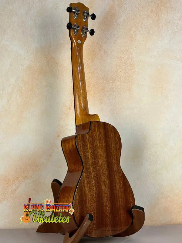 Ohana CK-60CG Mahogany Concert Ukulele elegantly displayed on a stand