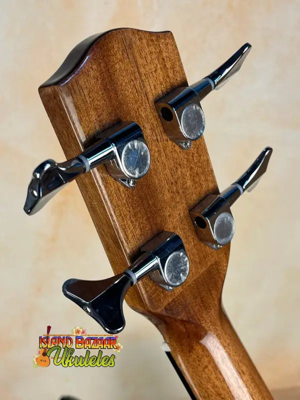 Wooden guitar headstock with black tuning pegs on Ohana OBU-22 U-Bass Rhythm Line Ukulele