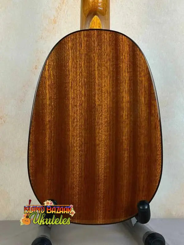Wooden acoustic guitar back panel on display stand for Ohana PKC-50G Solid Cedar Ukulele