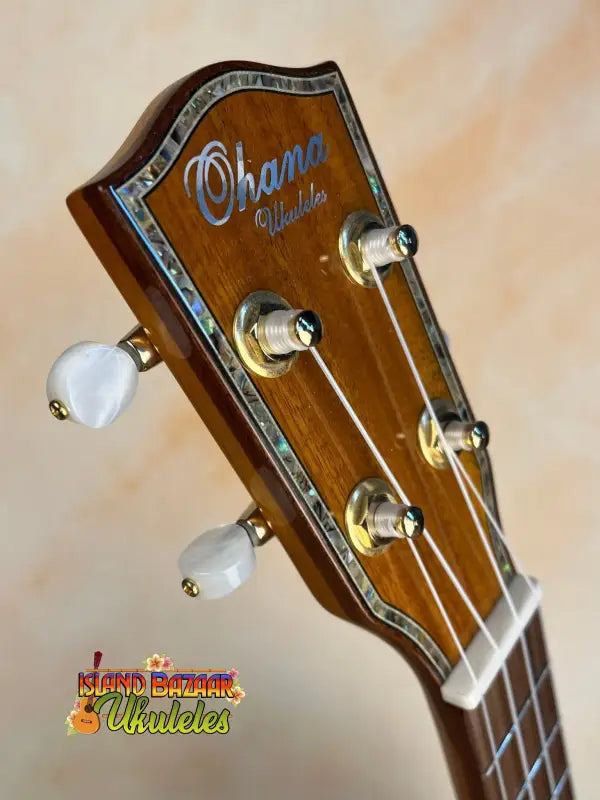 Wooden ukulele headstock with Ohana branding and white tuning pegs for Ohana TK-350G