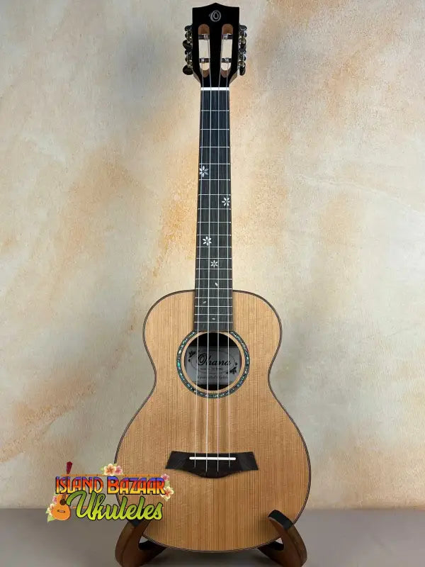 Natural wood Ohana TK-50ME Solid Cedar tenor ukulele with black tuning pegs and rosette