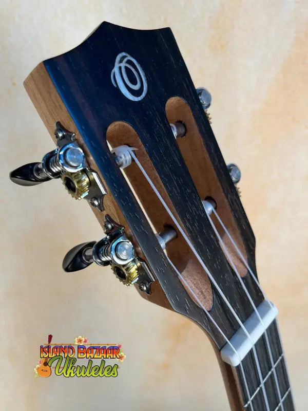 Guitar headstock with chrome tuning pegs showcasing Ohana TK-50ME Solid Cedar Tenor Ukulele