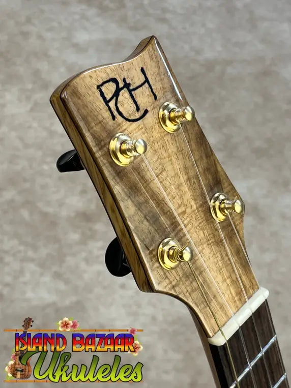 PCH custom tenor ukulele headstock with natural wood grain and gold tuners