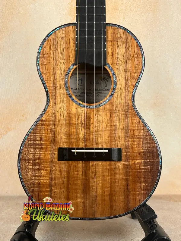 Ornate wooden tenor ukulele crafted by Phil Henderson from solid Hawaiian koa wood