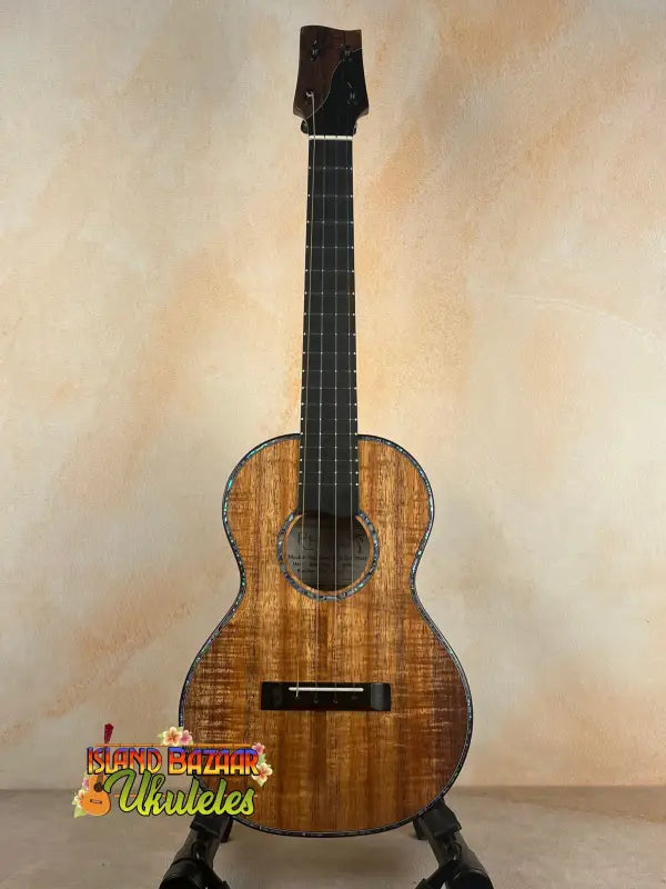 Brown wooden tenor ukulele with solid Hawaiian Koa from Phil Henderson’s PCH Sunshine collection