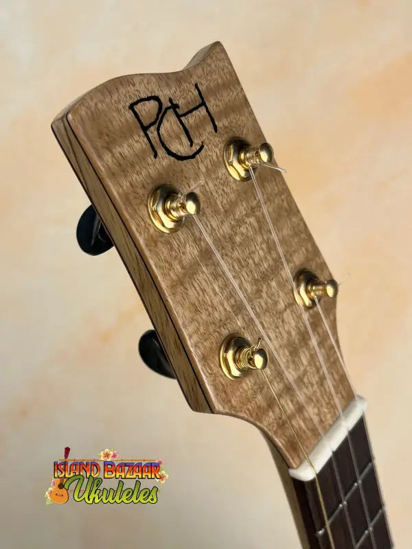 Wooden ukulele headstock with tuning pegs from Phil Henderson’s The Ladder Tenor Ukulele in solid Myrtle