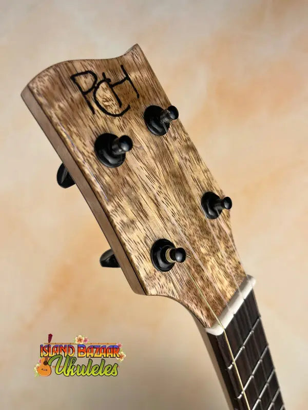 Ukulele headstock with tuning pegs, part of the Phil Henderson Solid Mango Tenor Ukulele