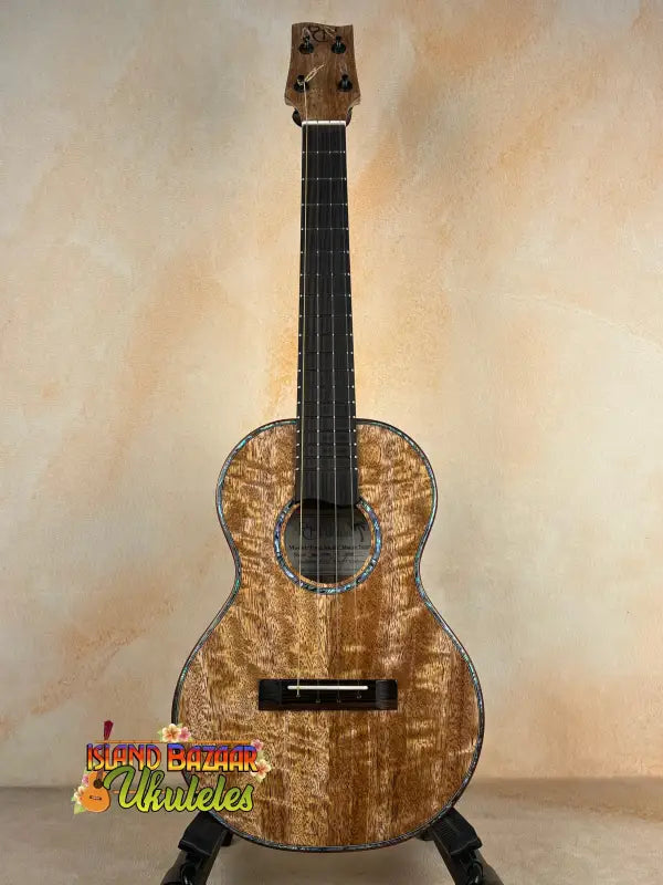 Brown figured wood ukulele featuring solid mango on the Phil Henderson Custom PCH Tenor Ukulele
