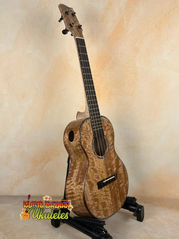 Wooden Phil Henderson Custom PCH Tenor Ukulele on stand in solid mango wood