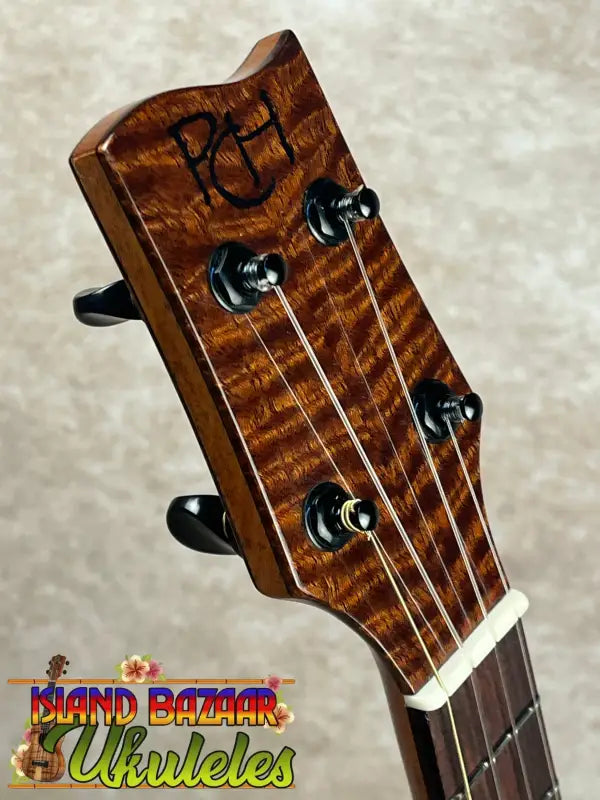 Ukulele headstock with black tuning pegs on Phil Henderson Custom Tenor Ukulele the ladder featuring PCH tenor ukulele luthier Phil Henderson