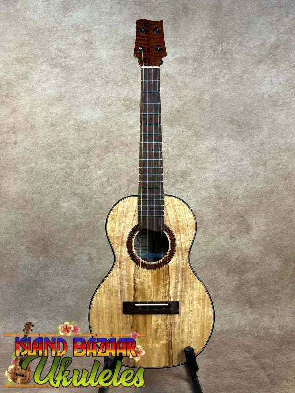 Wooden ukulele with dark fretboard from Phil Henderson’s PCH Tenor Ukulele series, the ladder