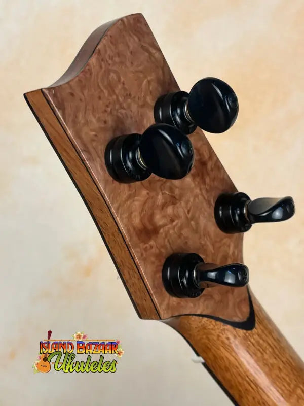 Guitar headstock with black tuning pegs on Phil Henderson Ukuleles Chocolate Thunder Solid Koa Tenor