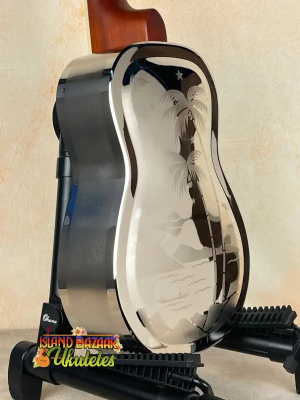 Shiny metal resonator concert ukulele with etched palm tree design from Tradewinds Resonator Concert collection