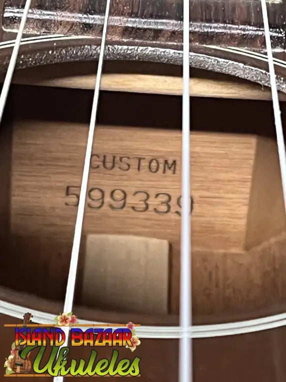 Custom vintage martin baritone ukulele with natural wood finish and engraved serial number 599339