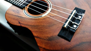 close-up of solid wood ukulele with elegant rosette and soft sunlight – handcrafted premium ukulele details