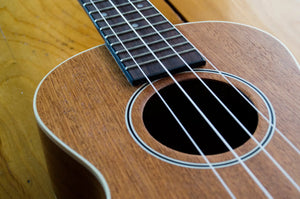 Detailed close-up of ukulele soundhole and strings – handcrafted ukuleles and expert setup at Island Bazaar Ukes