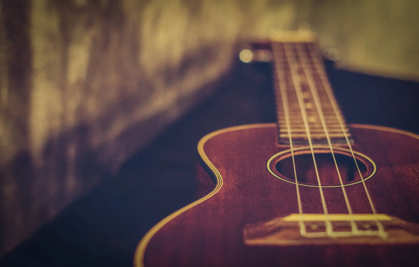 vintage-style ukulele in moody lighting on a bench – acoustic ukulele for rich tone and character