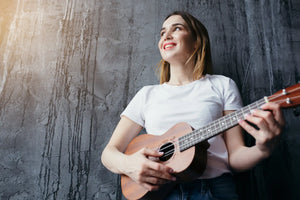 singer performing live on stage with an acoustic-electric ukulele – stage-ready ukuleles for musicians
