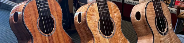 Phil Henderson custom ukuleles featuring three wooden ukuleles with side soundholes