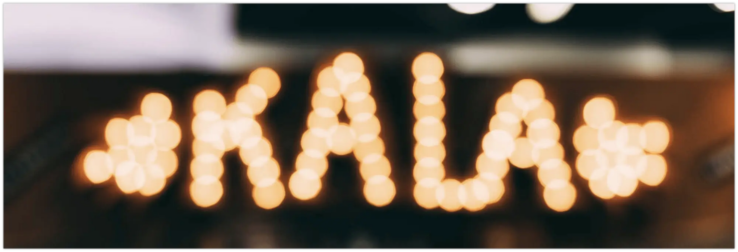 Illuminated KALA letters with decorative shapes showcasing Kala Ukuleles collection.