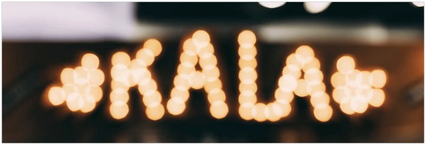 Illuminated KALA letters with decorative shapes showcasing Kala Ukuleles collection.