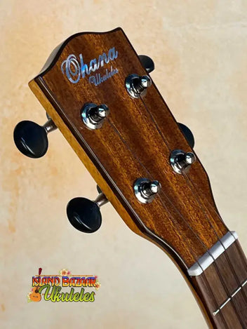 Three Ohana Ukuleles featuring solid cedar and cedar & rosewood lined up on a ledge.