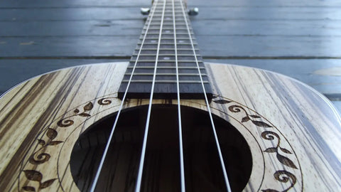 Acoustic guitar with floral patterns, perfect for experienced players at Island Bazaar Ukuleles.