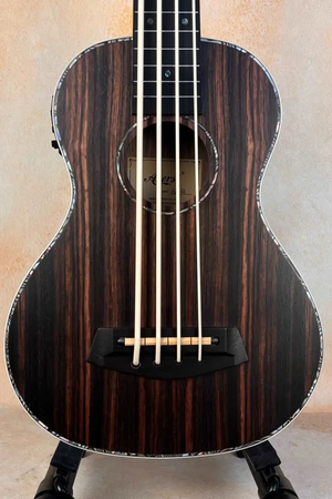 Striped Aiersi BU-33 Fretless Bass Ukulele with Ebony Body on a black stand