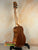 Wooden KoAloha KTM-00 Tenor Ukulele on stand showcasing authentic Hawaiian sound