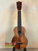 Wooden Kamaka Soprano Ukulele HF-1 with dark finish and black fretboard, solid Koa