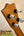 Guitar headstock with silver tuning pegs on a wooden surface of Kamaka Soprano Ukulele HF-1