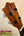 Wooden headstock of Kamaka Soprano Ukulele HF-1 with decorative arrow and tuning pegs