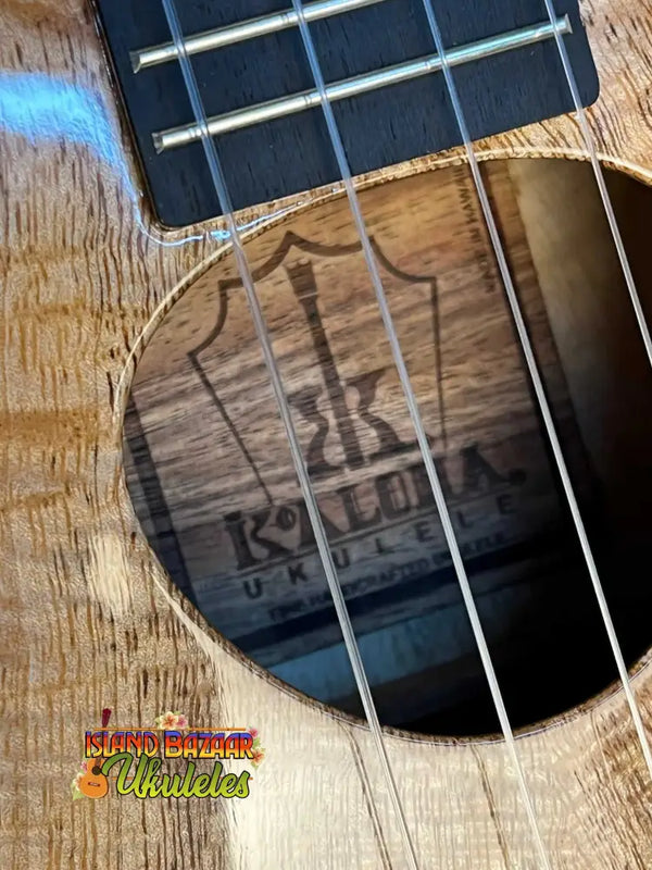 Wooden ukulele with visible strings and Kala logo inside KoAloha KTM-00 Mango Tenor Ukulele