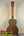 Wooden KoAloha Opio Concert Ukulele with natural grain finish and dark tuning pegs