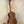 Wooden Concert Acacia Ukulele showcasing wood grain on a stand in a beginners bundle