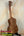 Wooden Concert Acacia Ukulele showcasing wood grain on a stand in a beginners bundle