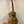 Wooden Concert Mango Ukulele with rich brown finish on black stand for beginners