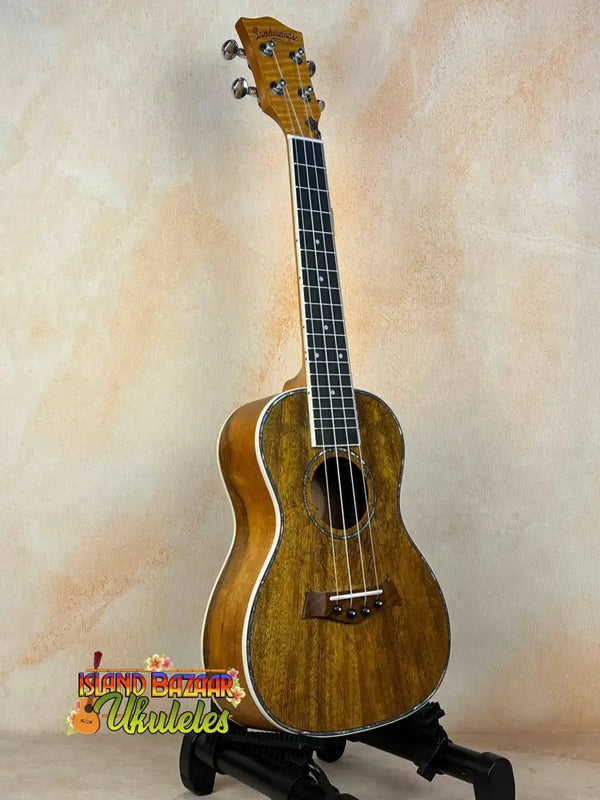 Wooden Concert Mango Ukulele with rich brown finish on black stand for beginners