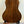 Wooden acoustic guitar with dark grain on stand, featuring Flight Sophia Soundwave Tenor