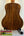 Wooden acoustic guitar with dark grain on stand, featuring Flight Sophia Soundwave Tenor