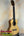 Natural wood Flight Sophia Soundwave Tenor Uke displayed on a black stand