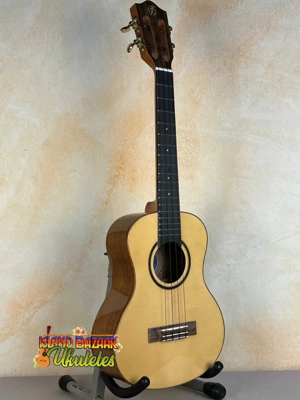 Natural wood Flight Sophia Soundwave Tenor Uke displayed on a black stand