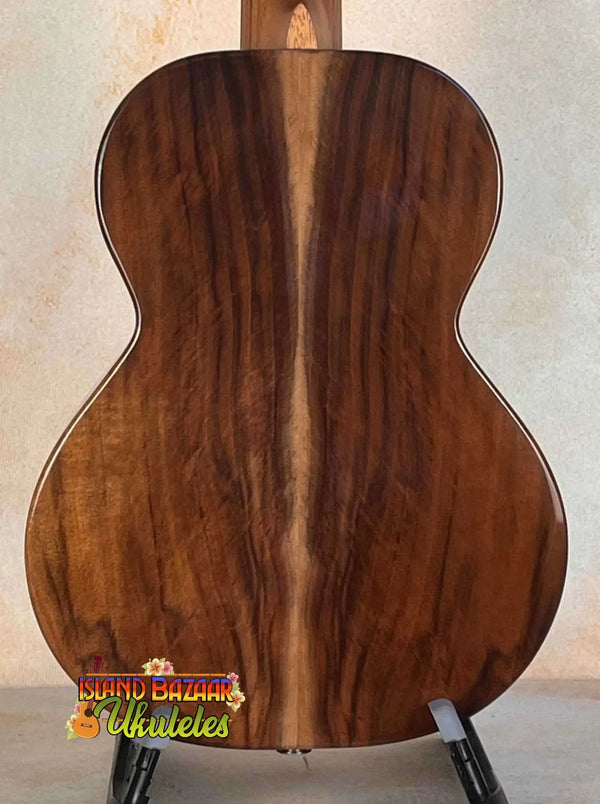 Wooden acoustic guitar back panel showcasing rich grain on Flight Voyager Tenor Ukulele