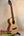 Natural wood Flight Voyager tenor ukulele on black stand with Flight gig bag