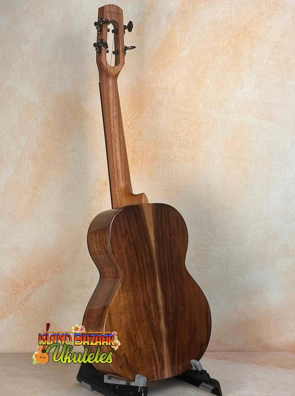 Wooden ukulele with rich brown finish on stand, part of Flight Voyager Tenor series