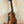 Wooden ukulele on black stand showcasing the Exquisite KoAloha KSM-00 Soprano Ukulele