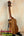 Wooden KoAloha KSM-00 Soprano Ukulele with rich brown grain on black stand