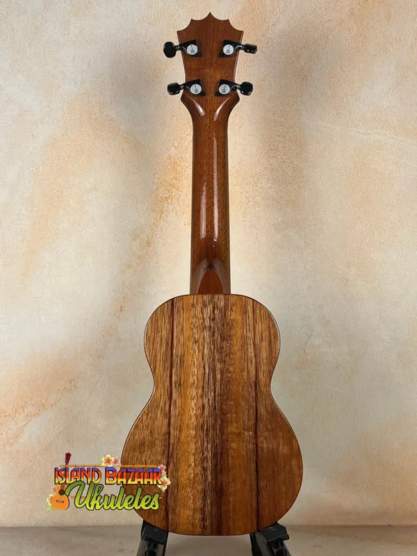 Wooden ukulele with grain and black pegs, featuring the Exquisite KoAloha KSM-00 Soprano Ukulele