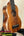 Wooden ukulele with brown finish and black fretboard, part of the Exquisite KoAloha KSM-00