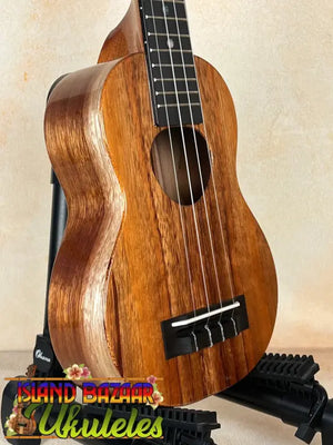 Wooden ukulele with brown finish and black fretboard, part of the Exquisite KoAloha KSM-00